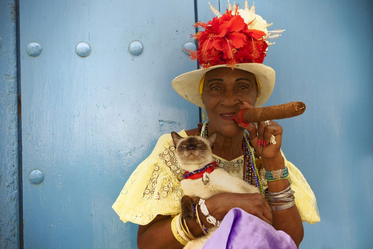 Cuban woman with a cigar and a cat