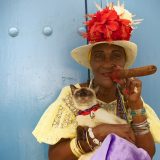 Cuban woman with a cigar and a cat