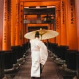Man with umbrella at shrine in Japan
