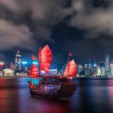 Red junk boat in Hong Kong Harbour at night