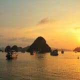 Halong Bay at sunset with boats